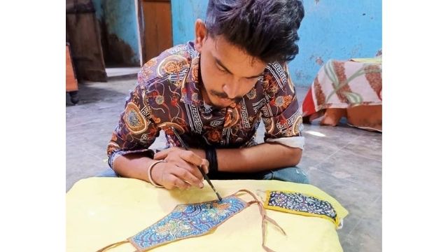 handmade masks Artisan doing hand made embroidery on double layered cotton masks